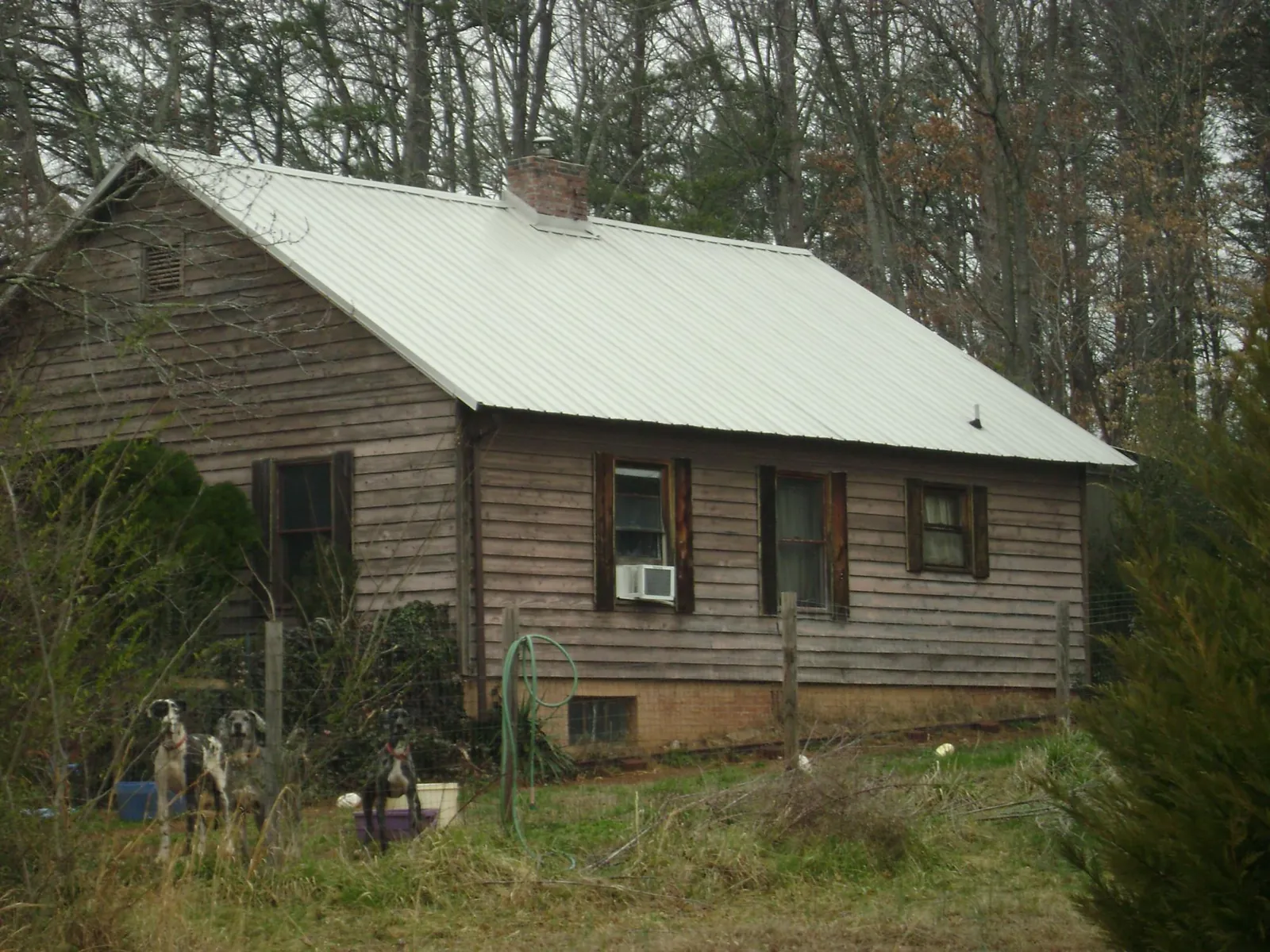 White metal roof on an old wood sided farmhouse, from a Metal Roof Installation job in Manchester